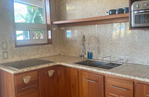 Corn Island House | 2 story home on beach, large breezy veranda for seamless indoor, outdoor living.