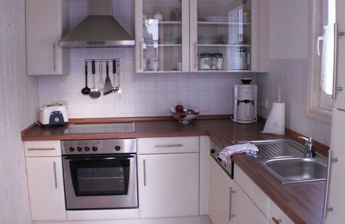 Gohren House | Child-friendly vacation home Ostseeblick 205 in Baabe. Cozy patio with a beach chair, patio furniture, and an outdoor grill. A spa with a whirlpool and sauna for a relaxing vacation