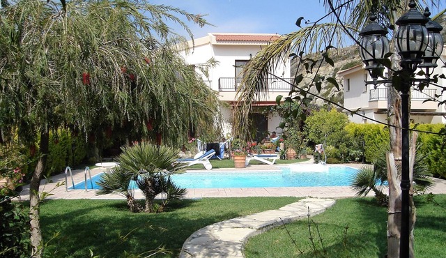 A luxury villa in beautiful gardens with pool.